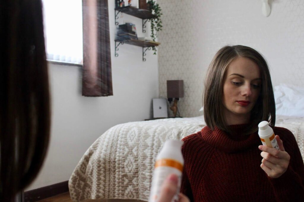 HYDRATING SKINCARE FOR WINTER. Claire looking at REN skincare product.