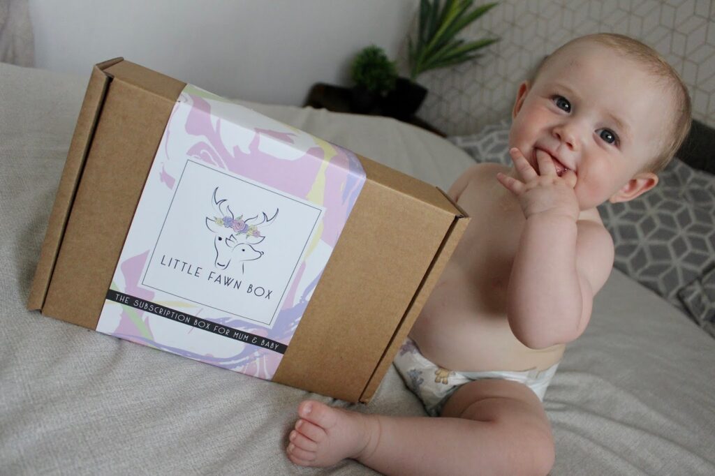 BABY GIRL SAT WITH UNOPENED LITTLE FAWN BOX