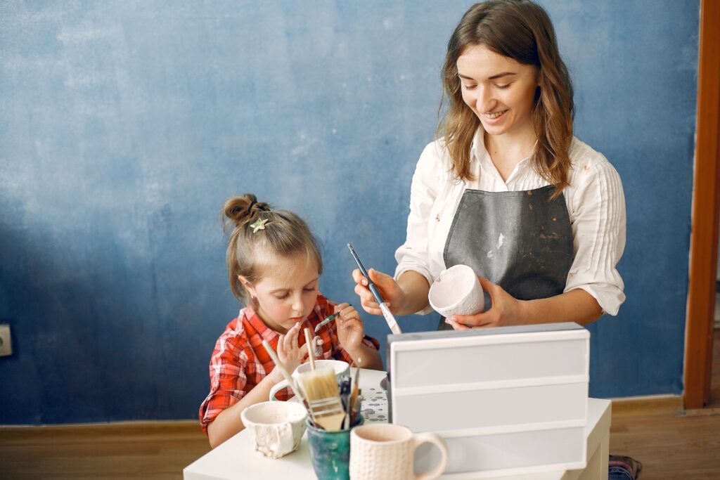 Mum painting with her daughter.