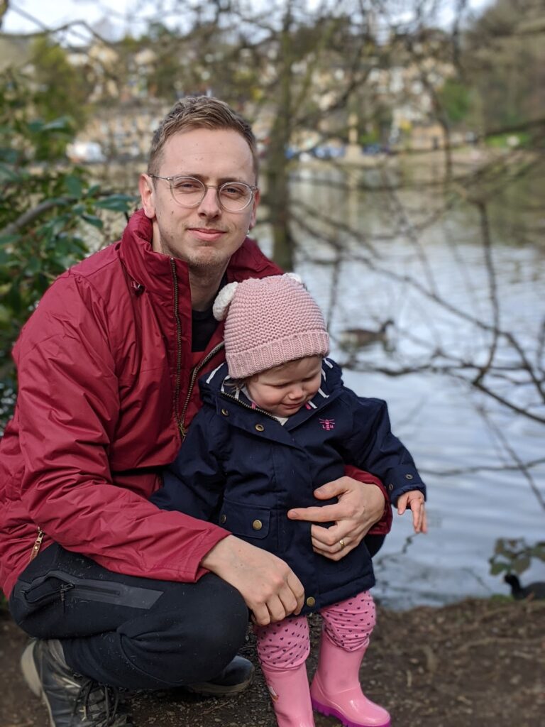 Father & daughter wearing Lighthouse raincoats in woodland scene. Woodland walks with Lighthouse Clothing.