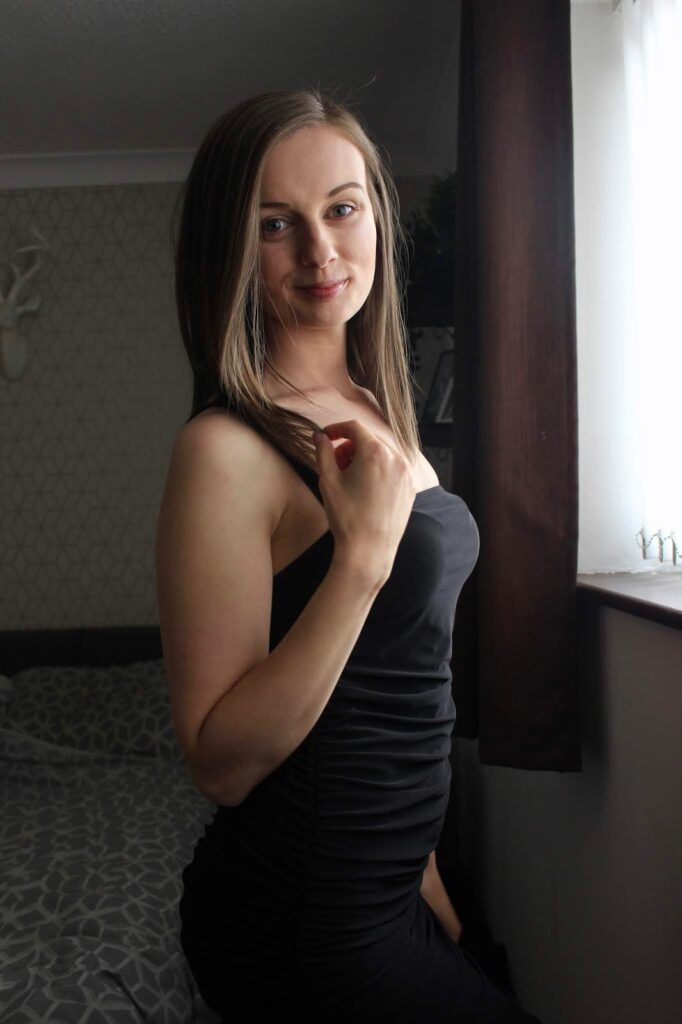 Claire confidently stood to the side wearing black slinky dress. Positive highlights from 2020.