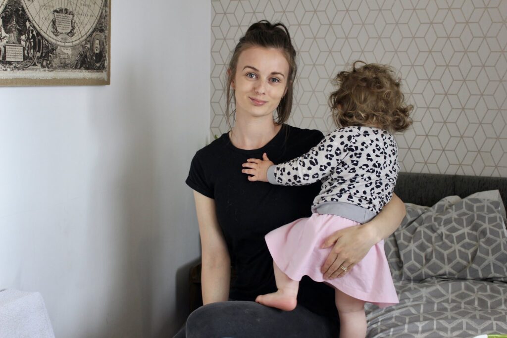 Claire facing the camera, sat with her daughter who looks away from the camera in a home setting. 10 indoor activities to cure our kids boredom in lockdown