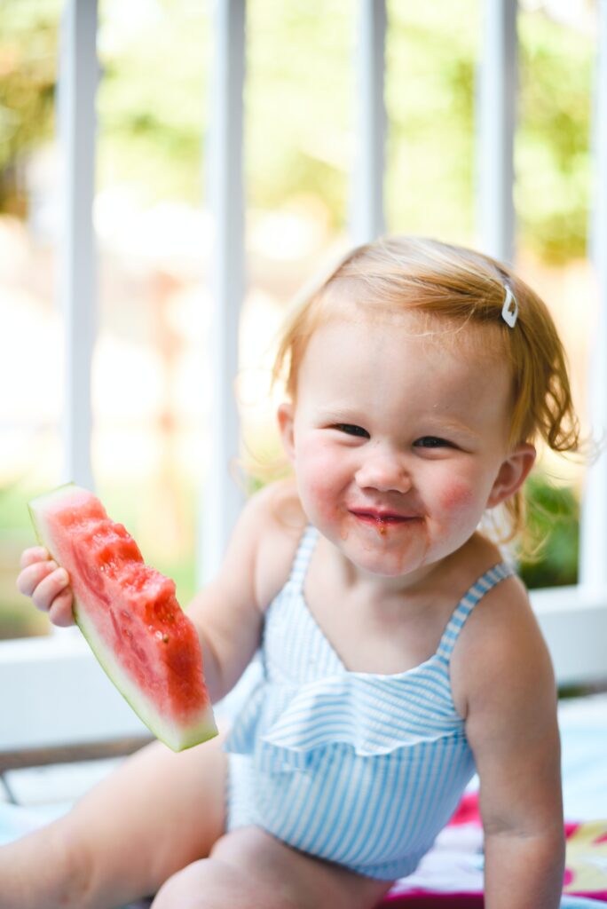 What causes fussy eating in toddlers. Toddler girl eating watermelon.