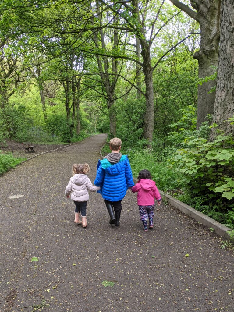 Image of my daughter and two friends walking off into the woods.