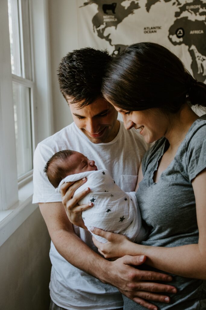 Calm parents holding their newborn baby.