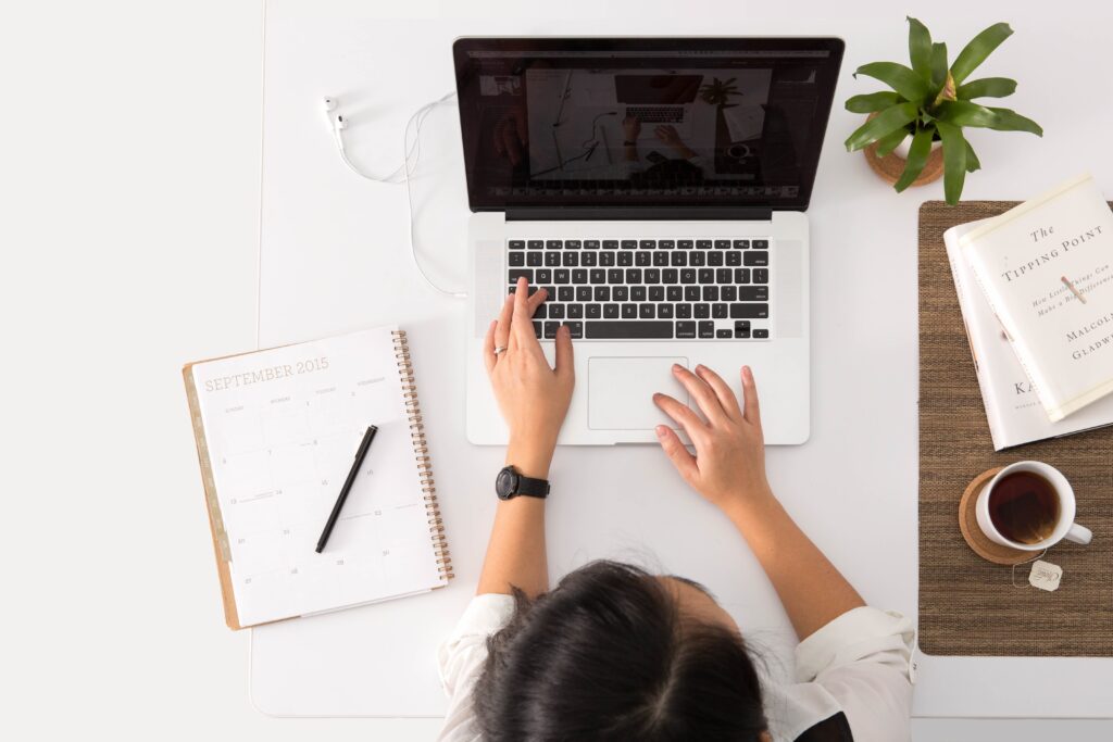 Woman working at laptop. How to improve your blogs DA score.