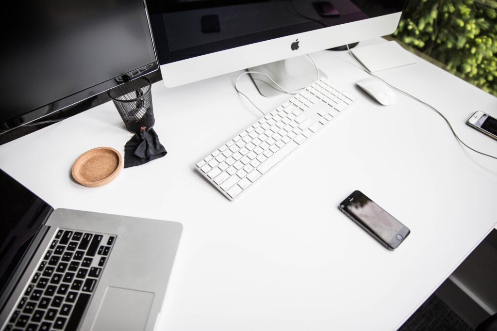 Laptop set up on white desk.