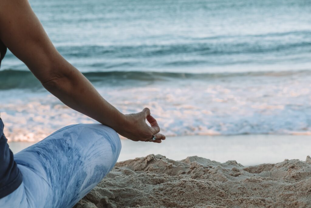 Practice yoga on the beach at one of the best wellness retreats in the UK.