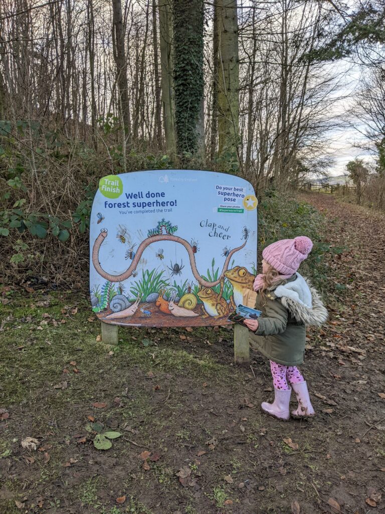 My daughter becoming a forest superhero as part of the Superworm trail.