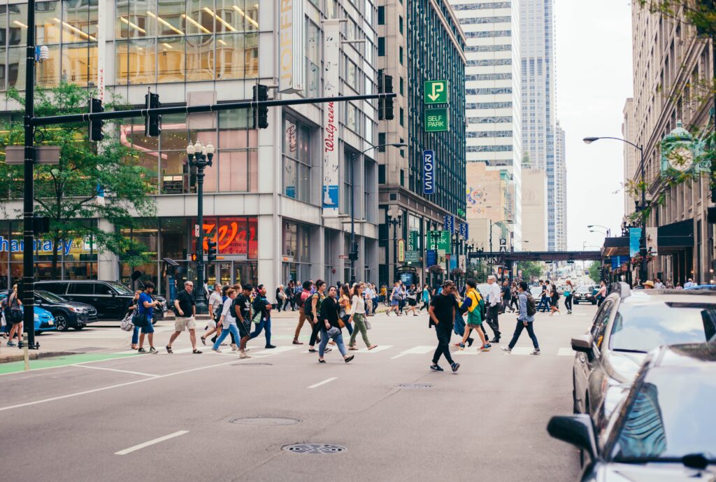 Image of city dwellers crossing the road. This is a post about what to do if you are hit by a car crossing the street.