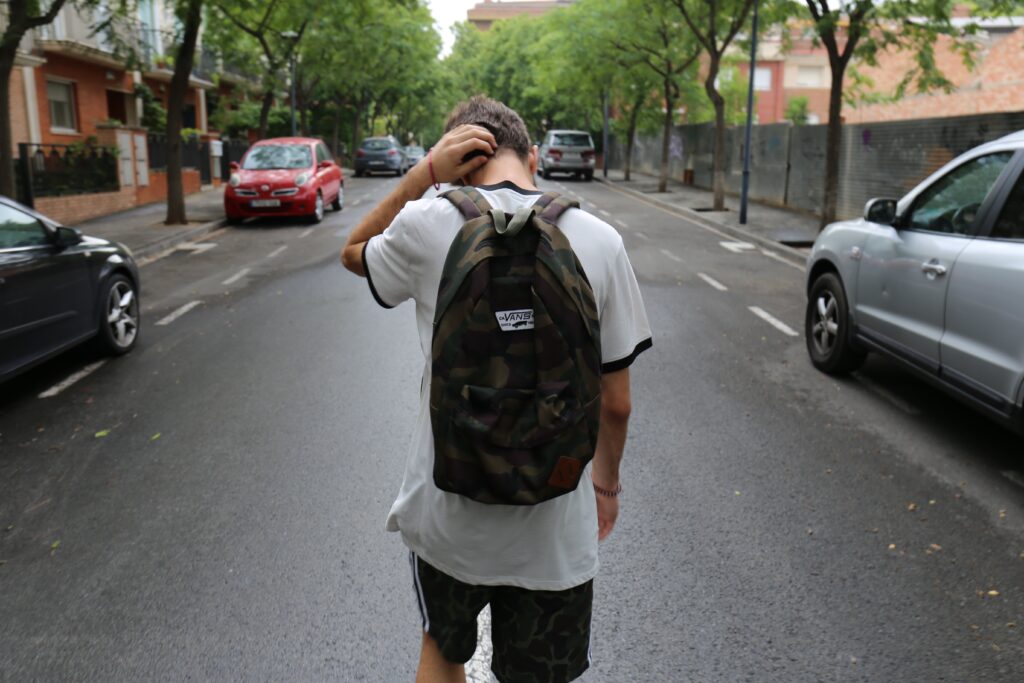 Picture of a teenage boy walking away. This post is about how you can be involved in your teens life.