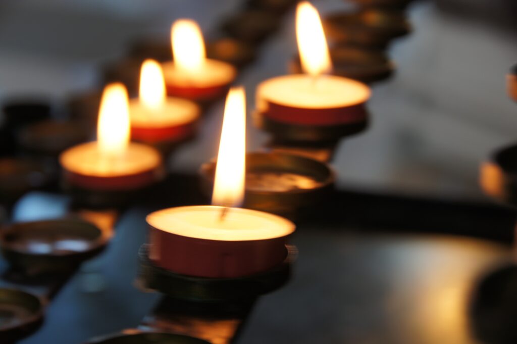 Lit candles. This post discusses funeral etiquette.