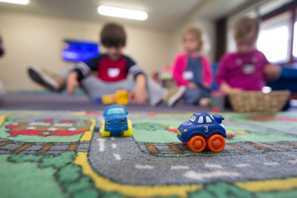 Children playing in a nursery setting. This post discusses whether nursery is the right choice for you and your child.