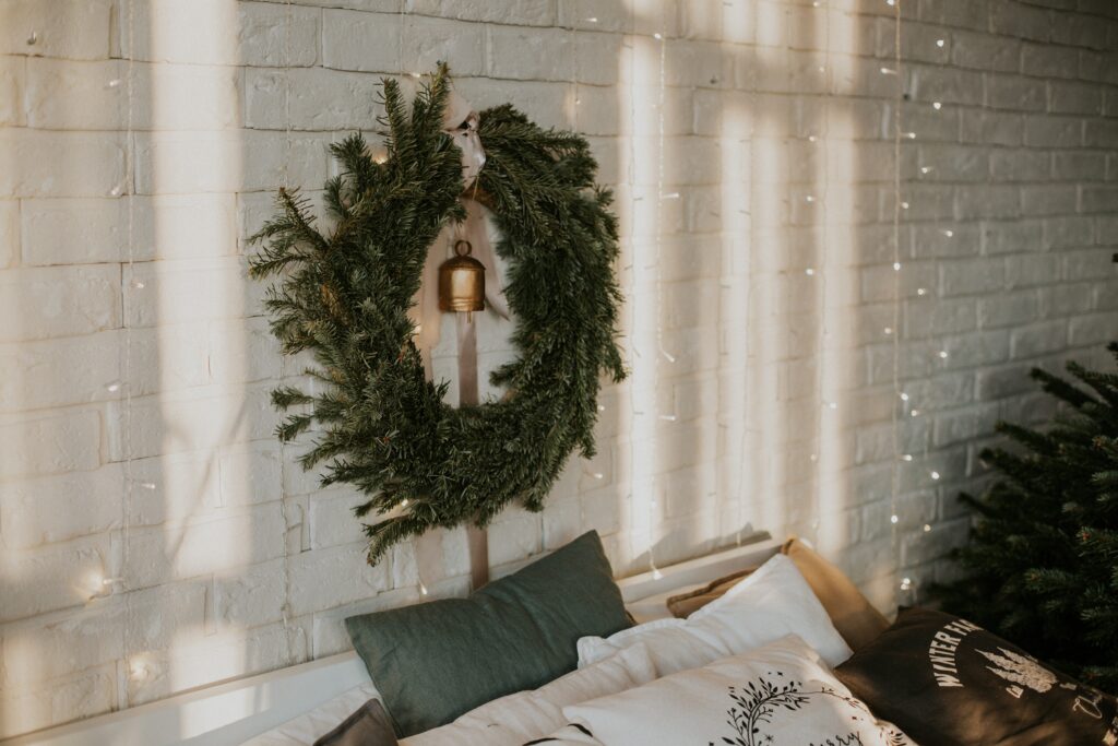 A Christmas wreath dressed about a bed ready for the festive season.
