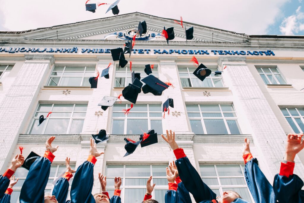 University graduates throwing graduation caps.