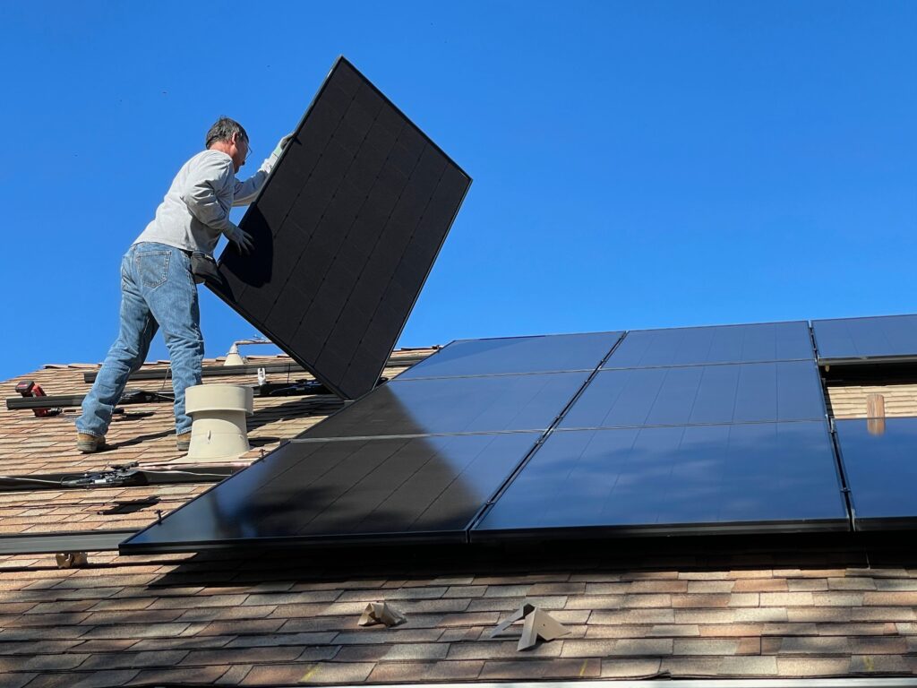 Man carrying out solar panel installation.