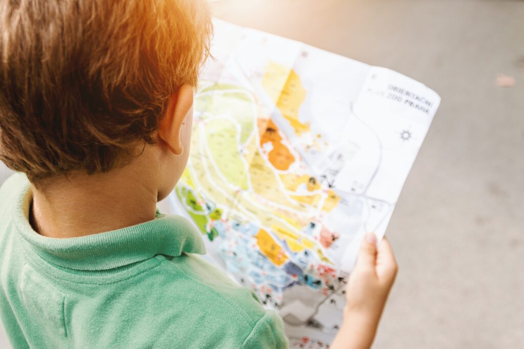 Child reading map. This is for an article discussing whether your child is ready for school or not & how to tackle the situation.