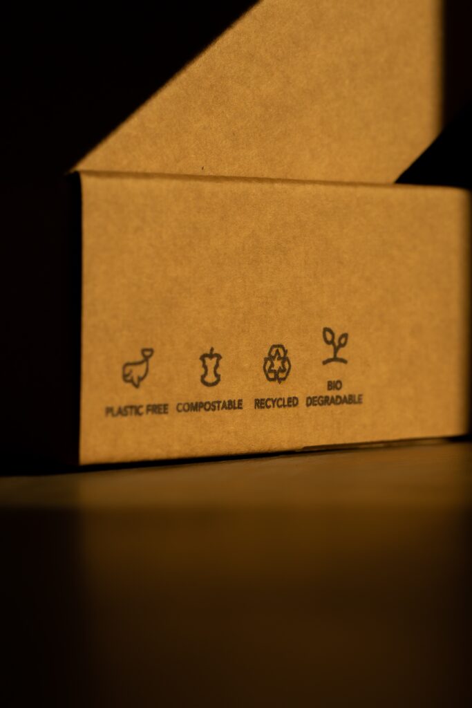 Image of cardboard box with symbols on showing its sustainability benefits. This includes being plastic free, compostable and recyclable.
