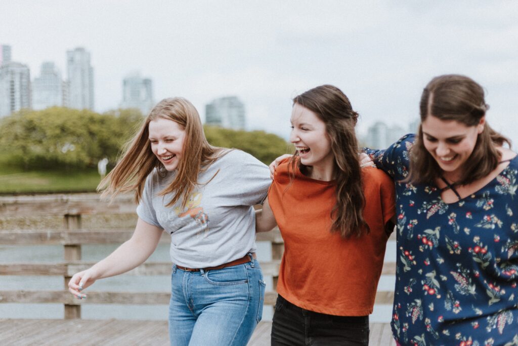 Women larking around together. This is for a blog post discussing embracing vulnerability and sharing struggles of motherhood.