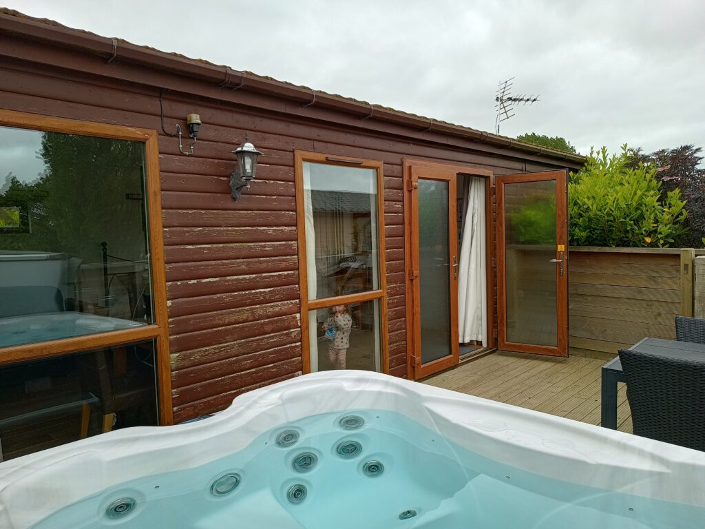 Looking over the hot tub to our studio lodge at Barker Stakes Farm.