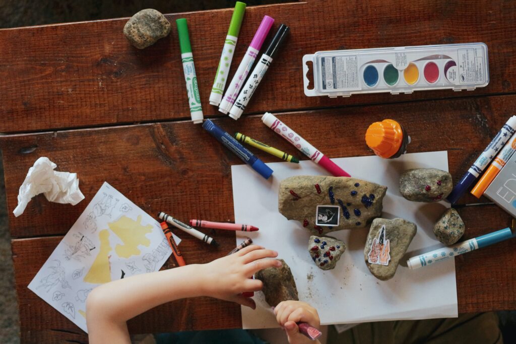 Child playing with different arts and crafts. This is for a blog post promoting unstructured play.