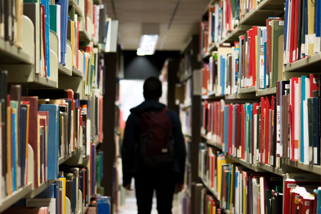 Student walking through school library. This is to go with an article discussing how schools can support pupil wellbeing.