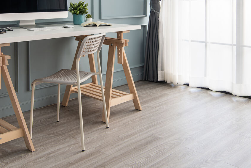 Modern interior. Comfortable workplace. Wooden table with beautiful and computer, luxury vinyl tile wood floor in the office.