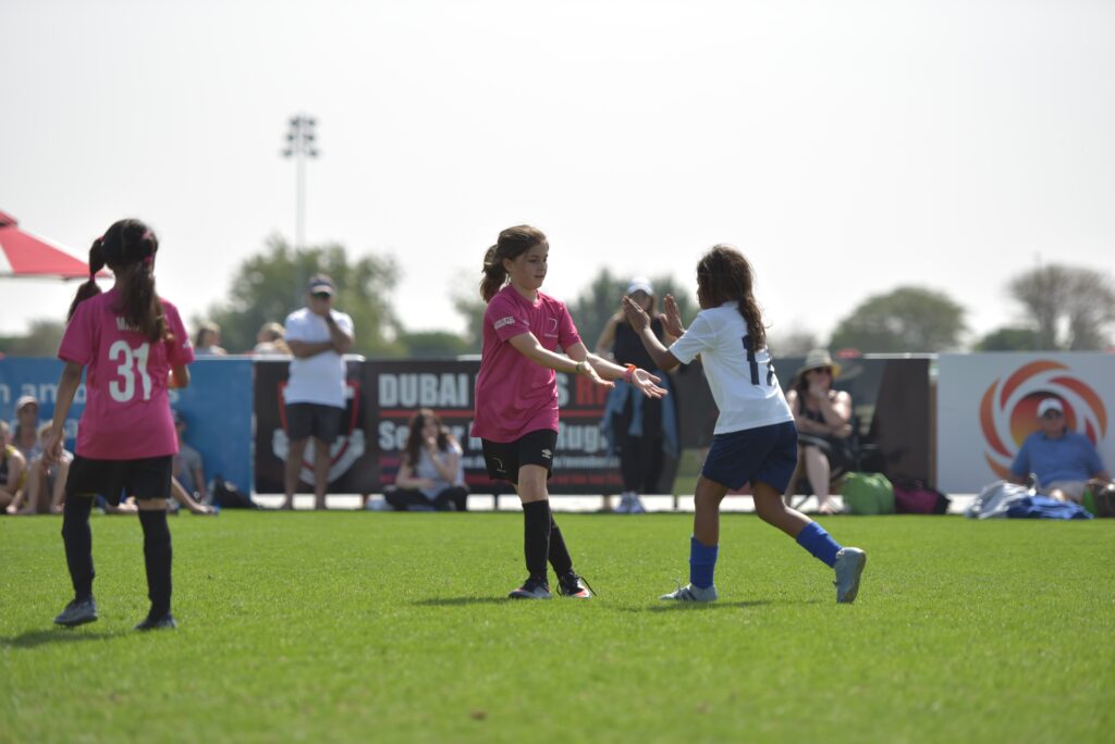 Young girls playing football. This is to go with an article discussing what is the best age for kids to start playing football.