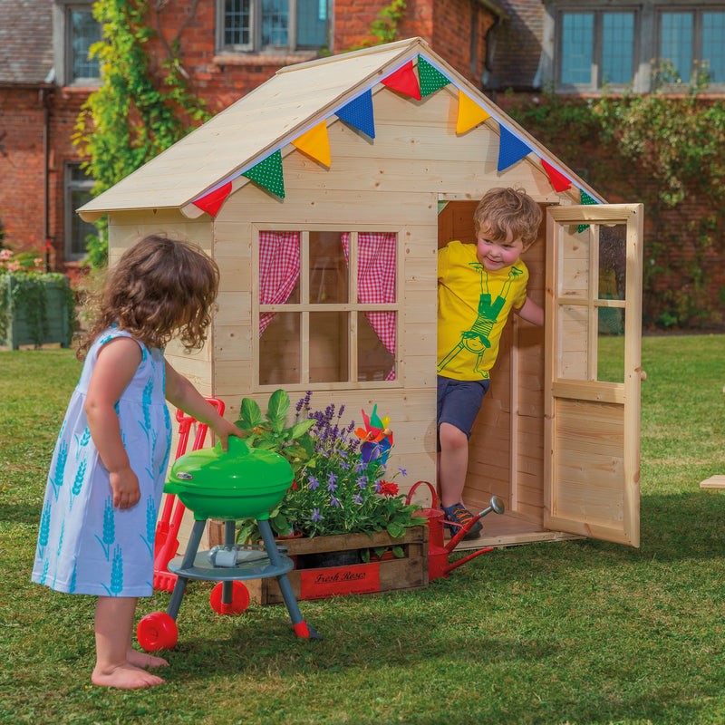 Children playing inside wendy house - Showing the benefits of outdoor education.