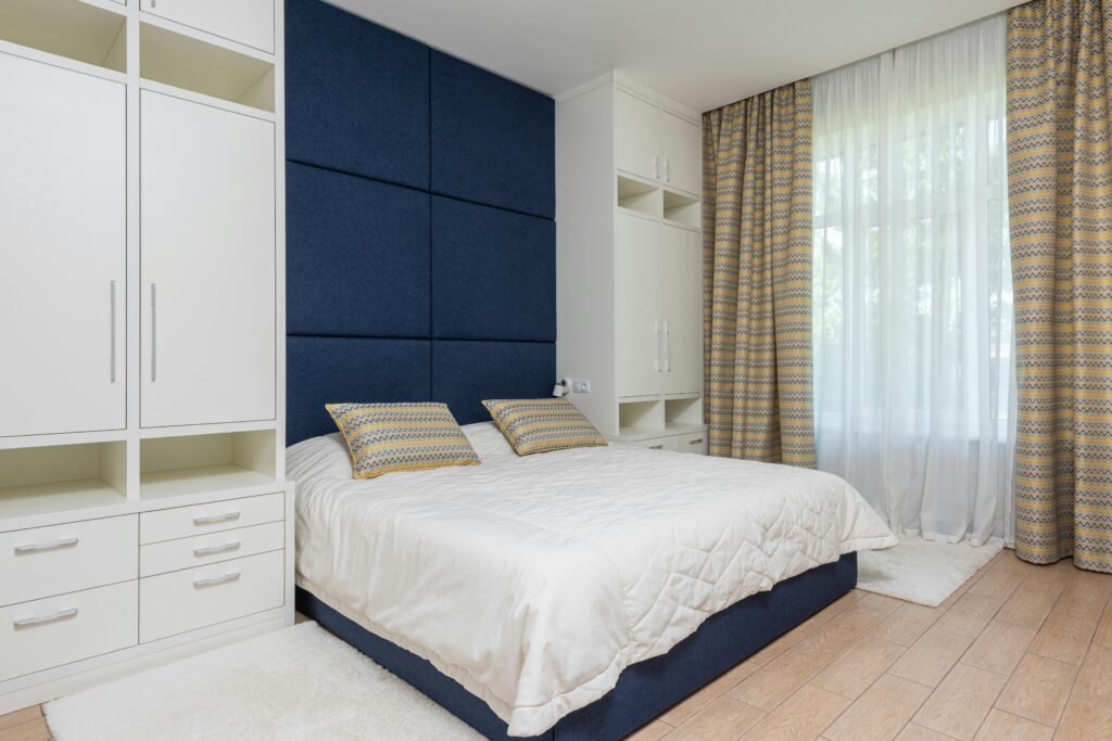 One wall storage solutions like in this bedroom here is one of the interior design trends for 2024.
