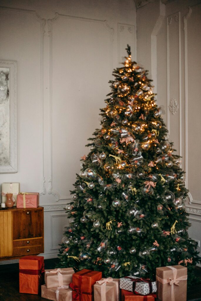 A large christmas tree decorated beautifully in a home.