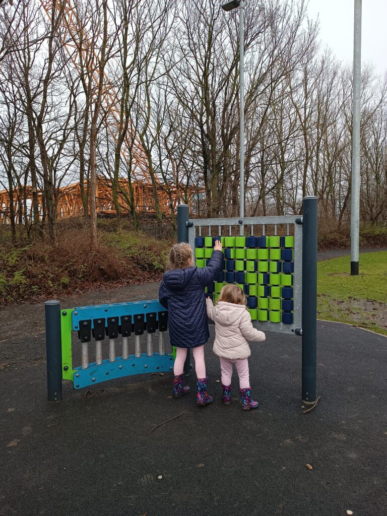 Two children playing at the play park at Teessaurous Park.
