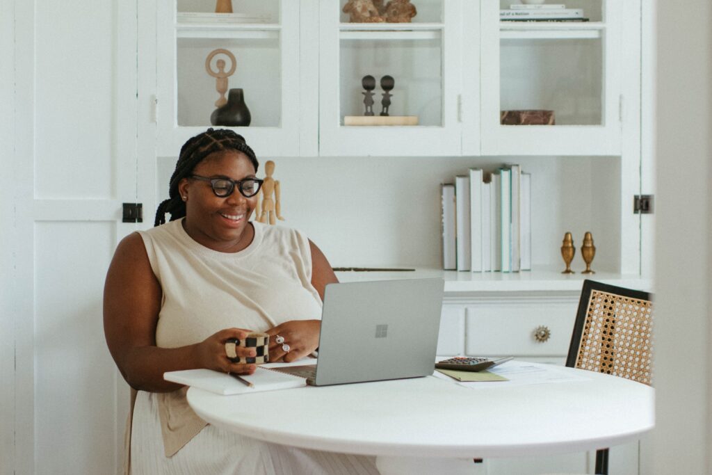 Woman sat in front of laptop on business zoom call.