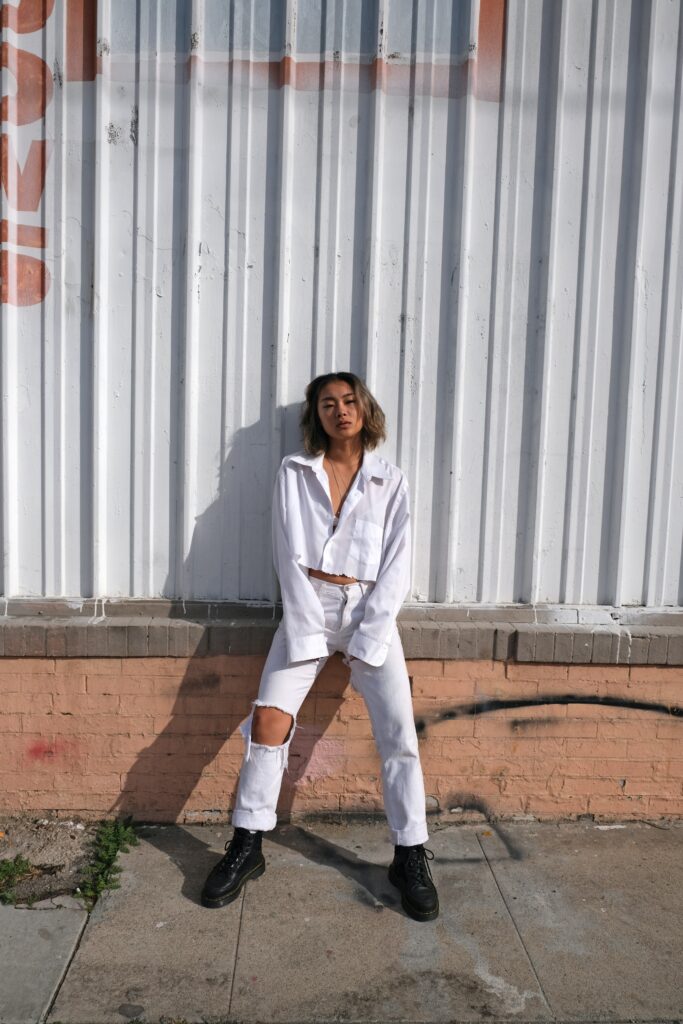 Influencer modelling white shirt and white ripped jeans. This is Boosting Sales for Fashion Wholesalers.