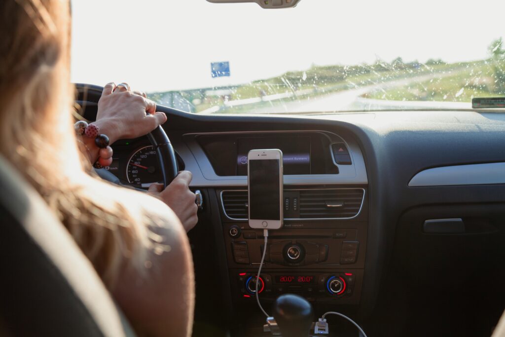 Woman driving during road trip with kids.