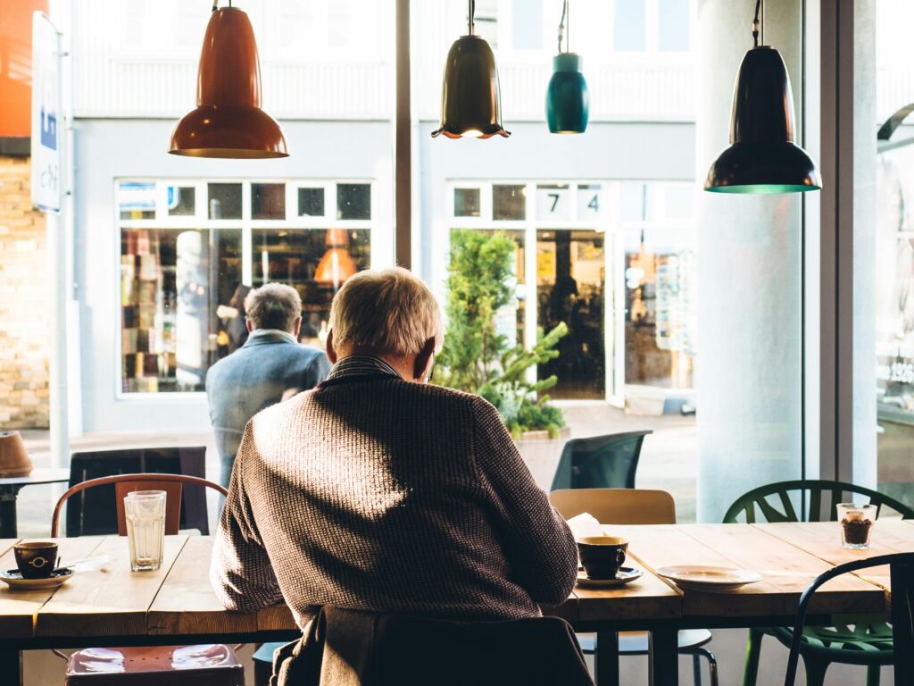 Man living out dream retirement in coffee shop.