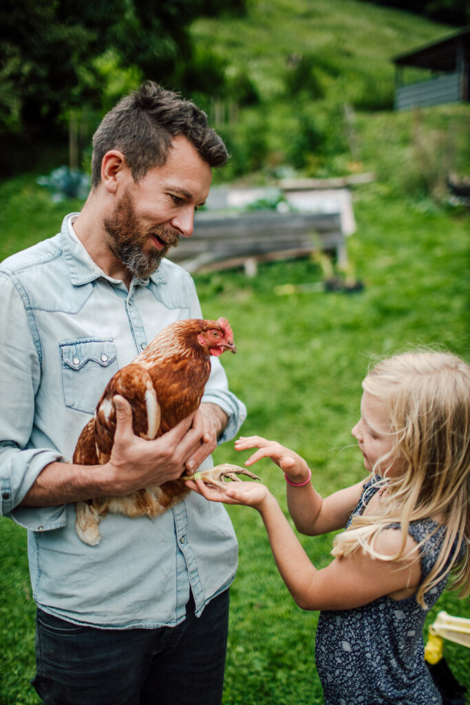 Man holding chicken.