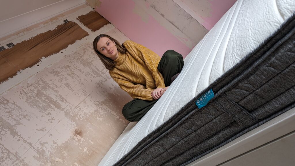 Claire Mac sat on Origin Hybrid Mattress.