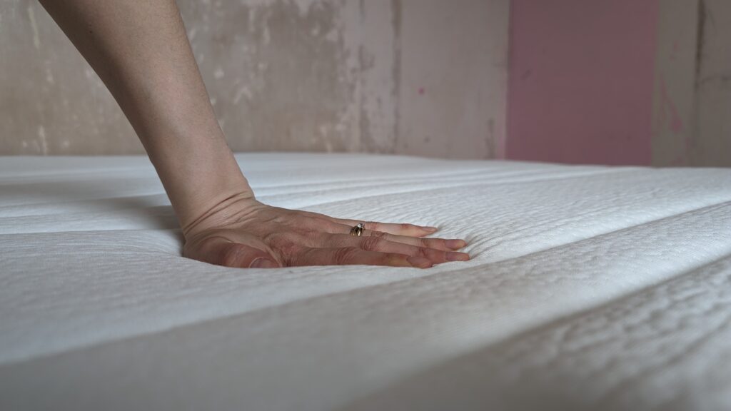 Hand print into the Origin Hybrid Mattress.