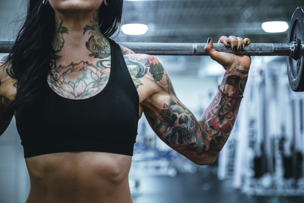 Woman working out with dumbells. This is to go with a blog post giving tips for how to stay motivated to workout at home.