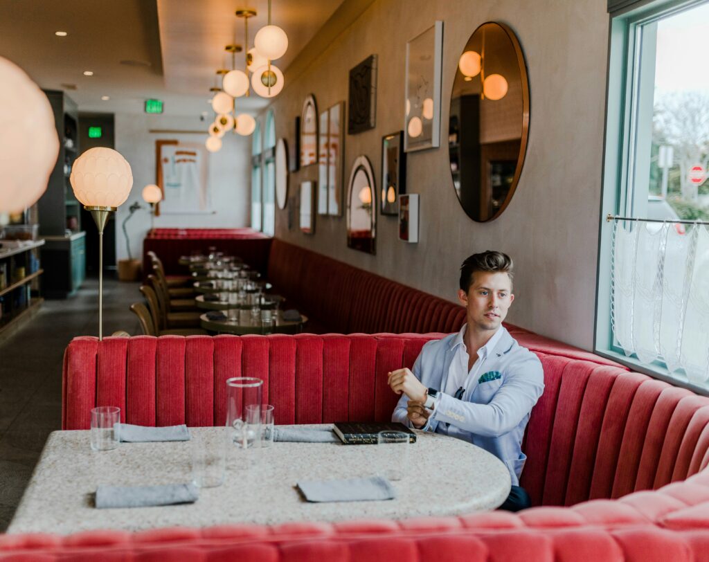 Man waiting in dining room settigng.