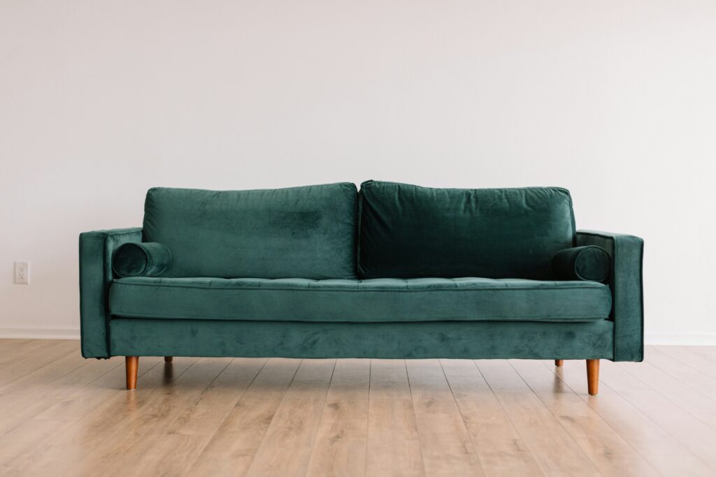 A green velvet sofa. This image is to go with an article discussing the art of upholstery.
