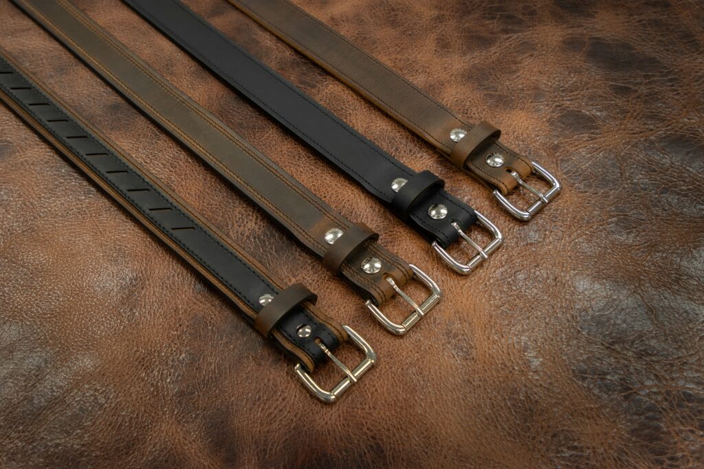 Four leather belts lined up in a row. This is to go with an article giving tips for how to take care of your accessories.