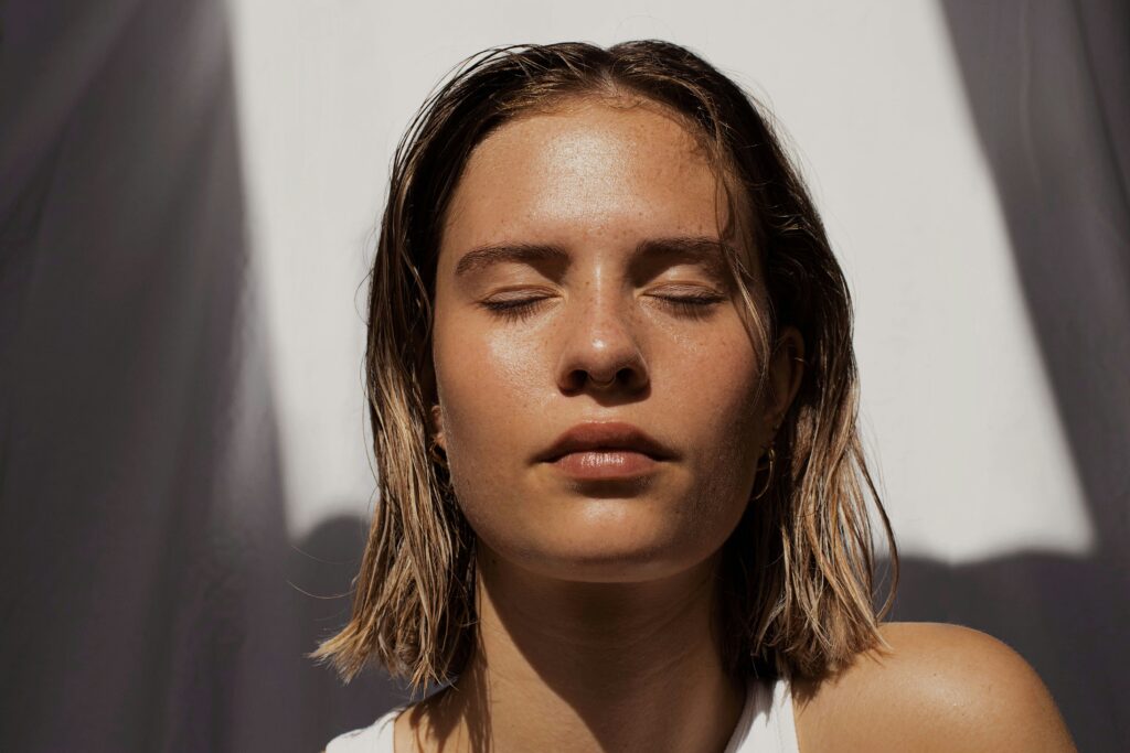 Blonde haired lady with clear, glowy skin.