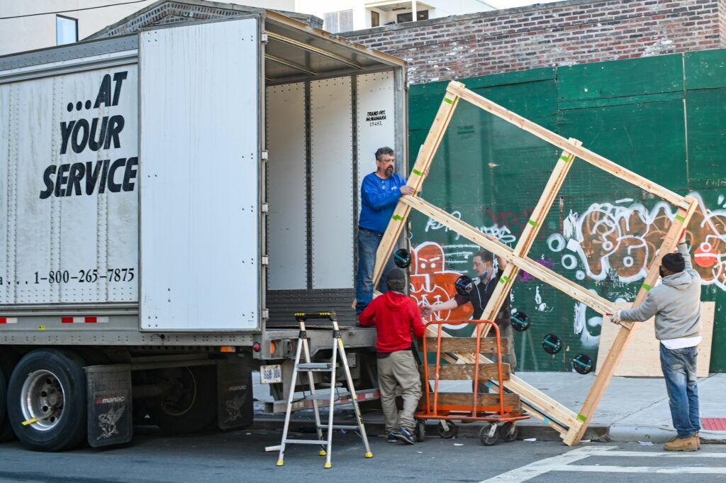 Image of men working as a removal team. This is to go with an article discussing reasons to hire a removal company.