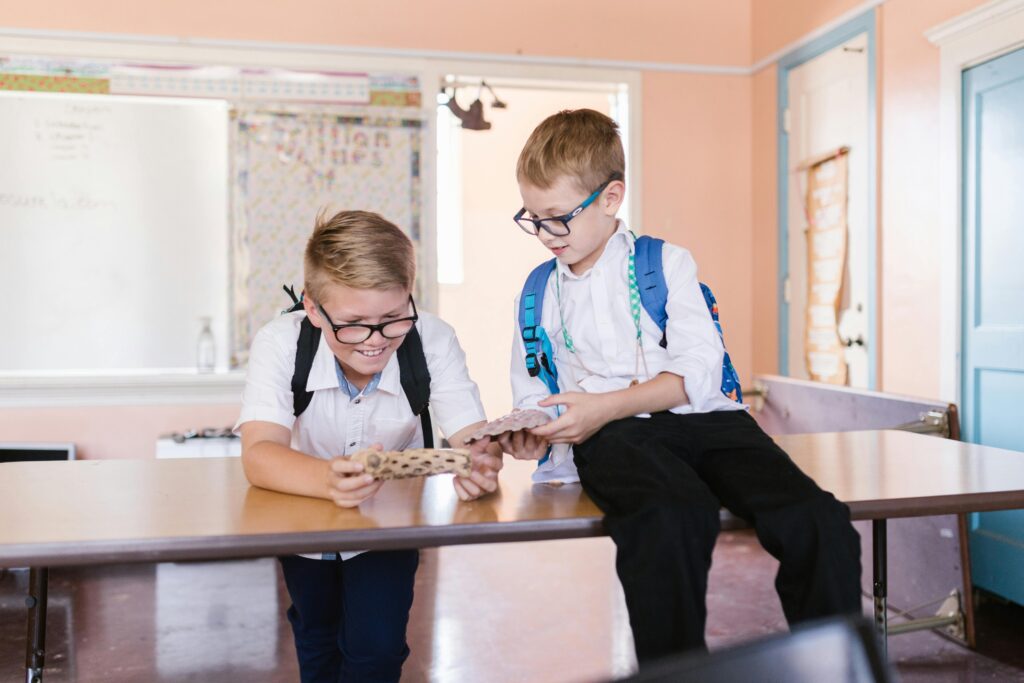 Two boys wearing school uniform.