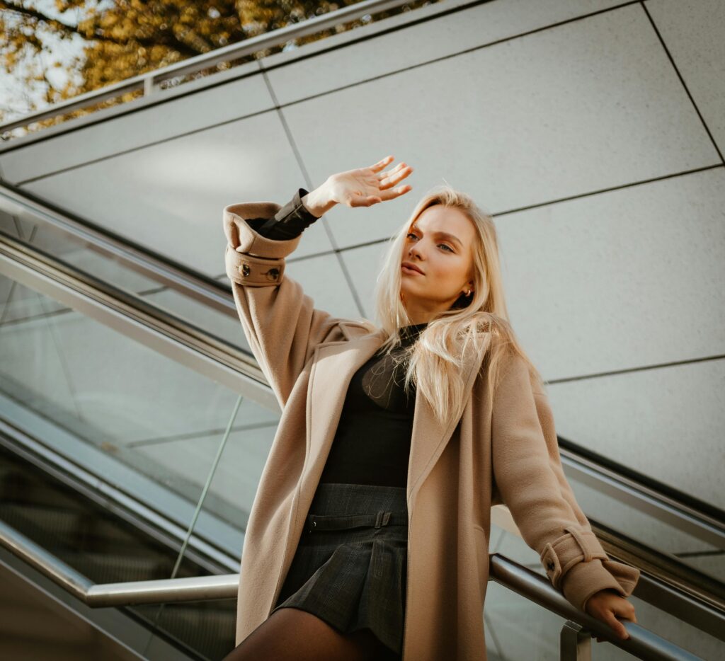 Woman wearing camel coloured coat.