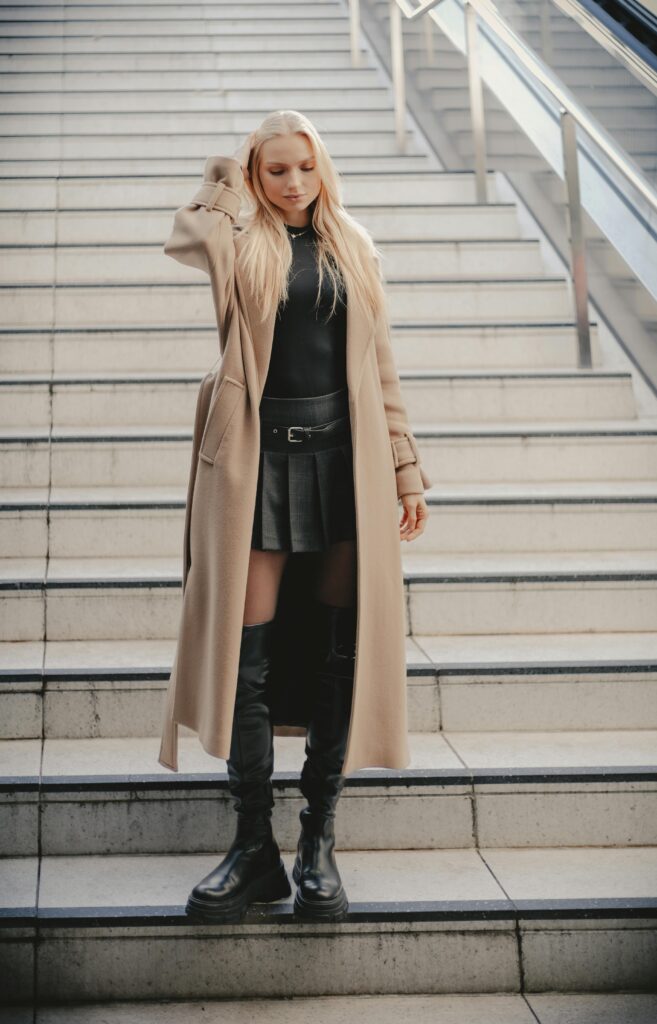 Blonde haired woman wearing an autumnal outfit.