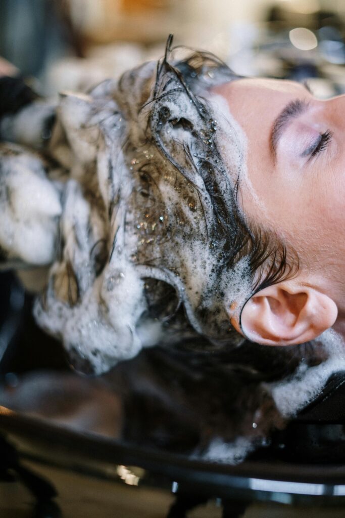 Close up of a woman having her hair washed a a salon.