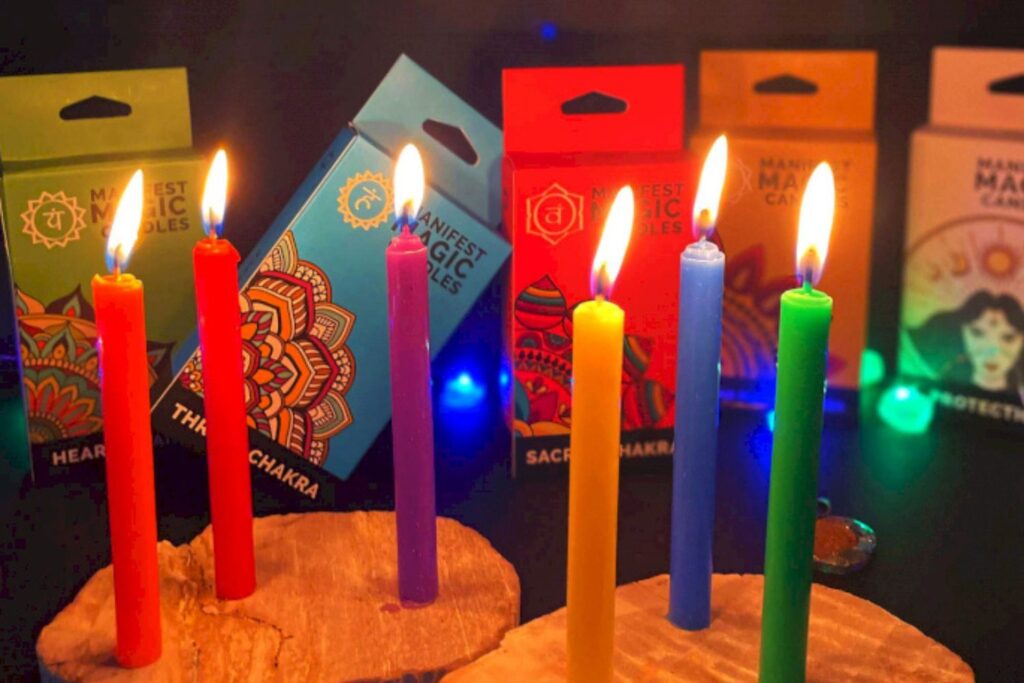 Colourful candles lined up lit.
